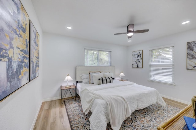 bedroom featuring multiple windows, recessed lighting, wood finished floors, and baseboards