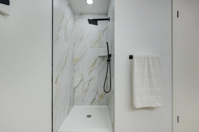 bathroom with a marble finish shower