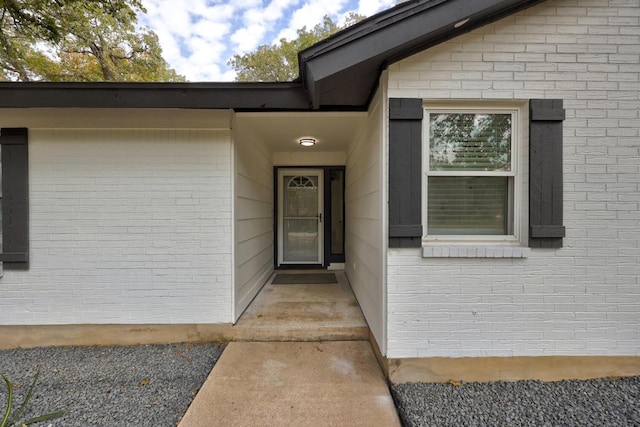 property entrance with brick siding