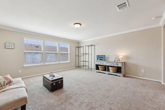 living room with a textured ceiling, carpet flooring, visible vents, baseboards, and ornamental molding