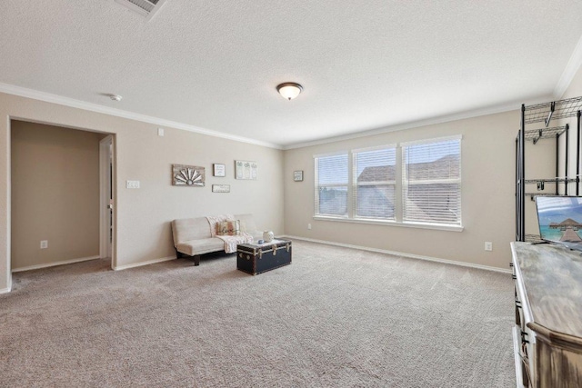 sitting room featuring carpet floors, a textured ceiling, and crown molding