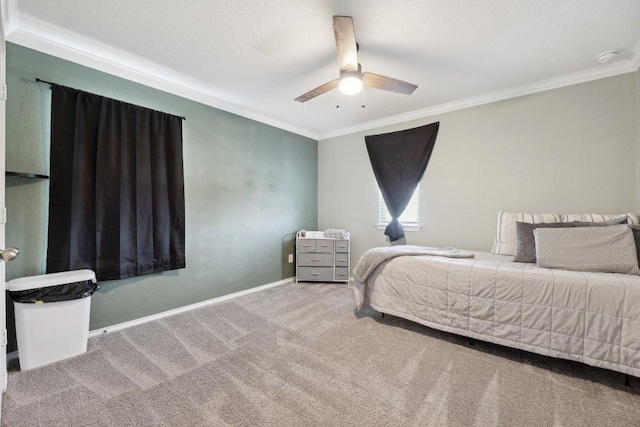 bedroom featuring carpet floors, ceiling fan, baseboards, and crown molding