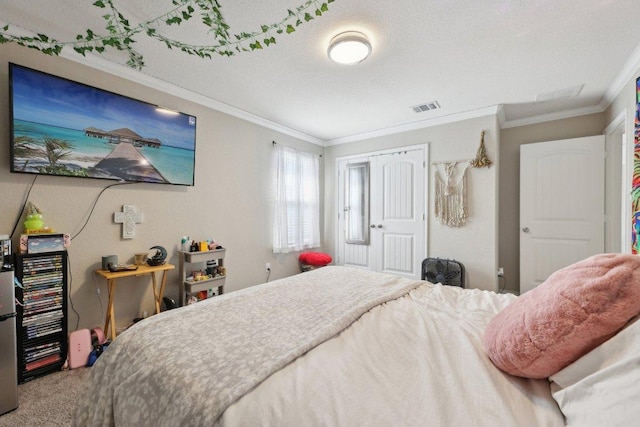 carpeted bedroom featuring visible vents, a textured ceiling, and ornamental molding