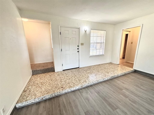 foyer entrance with wood finished floors and baseboards