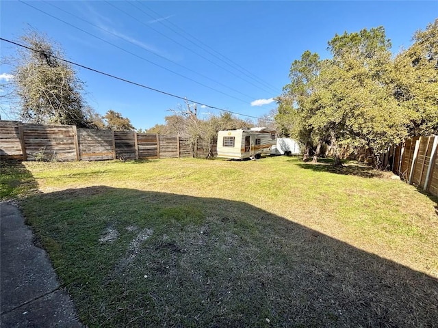 view of yard featuring an outdoor structure and a fenced backyard