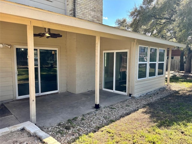 exterior space with a patio, a chimney, and ceiling fan