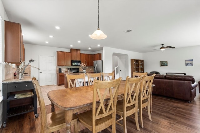 dining room with visible vents, arched walkways, ceiling fan, wood finished floors, and recessed lighting