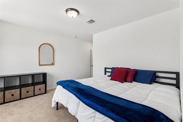 carpeted bedroom featuring baseboards and visible vents