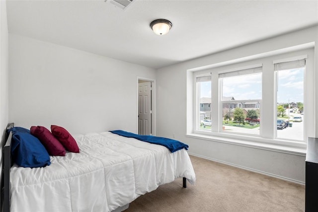 bedroom with carpet, visible vents, and baseboards