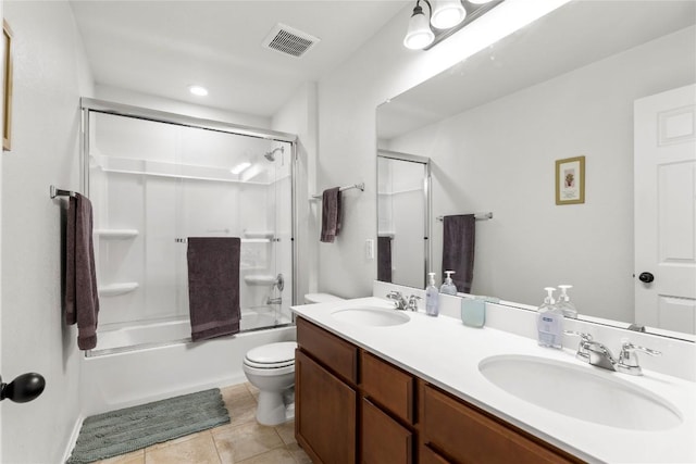 bathroom featuring toilet, a sink, visible vents, and tile patterned floors