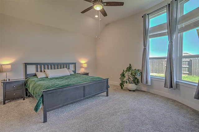 carpeted bedroom with baseboards, vaulted ceiling, and a ceiling fan