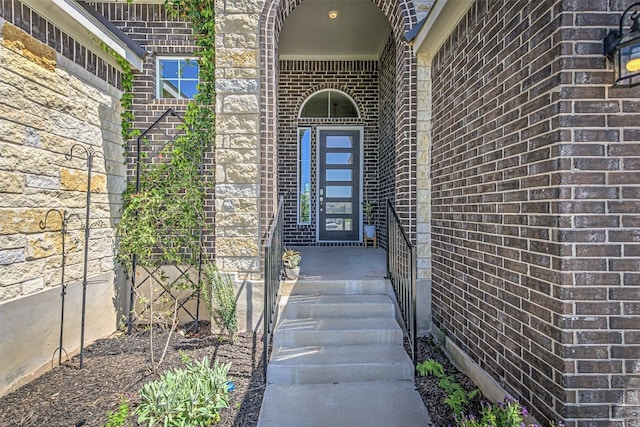 property entrance featuring brick siding