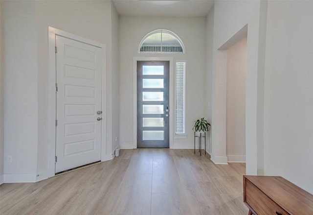 entrance foyer featuring light wood-type flooring and baseboards