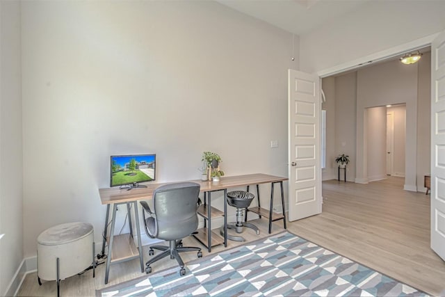 office with baseboards and wood finished floors