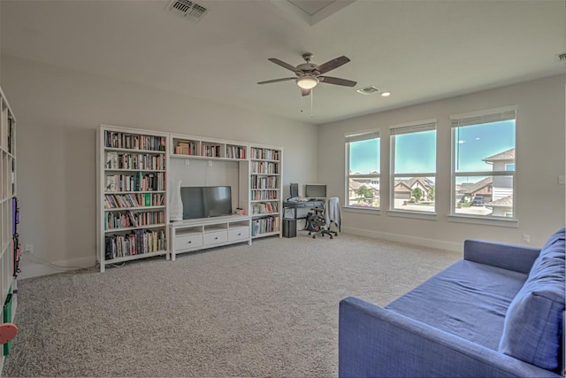 carpeted living room with a ceiling fan, visible vents, and baseboards