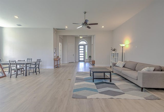 living area with light wood finished floors, ceiling fan, baseboards, and recessed lighting