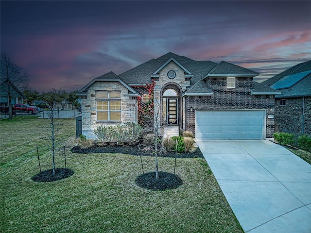 20933 Claire Jean Path, Pflugerville, TX 78660 - french country inspired facade with roof with shingles, driveway, a lawn, stone siding, and an attached garage