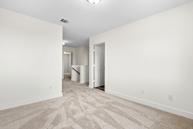 unfurnished room featuring carpet floors, visible vents, and baseboards