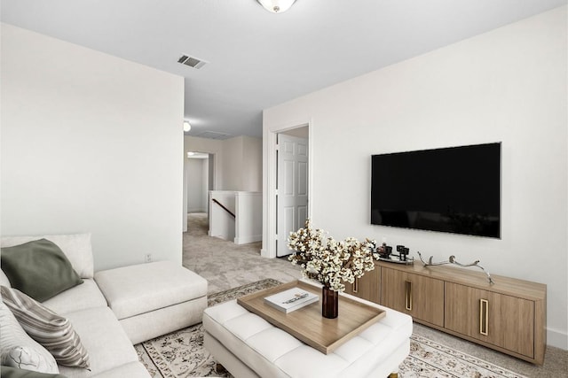 living area featuring light carpet and visible vents