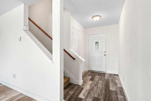 foyer featuring stairway, baseboards, and wood finished floors