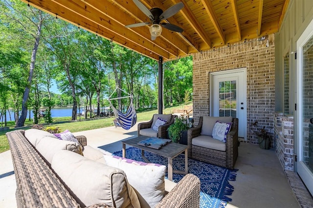 view of patio / terrace with a water view, ceiling fan, and outdoor lounge area