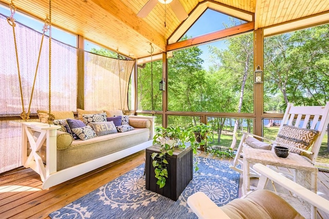 sunroom / solarium featuring vaulted ceiling, wooden ceiling, and a ceiling fan