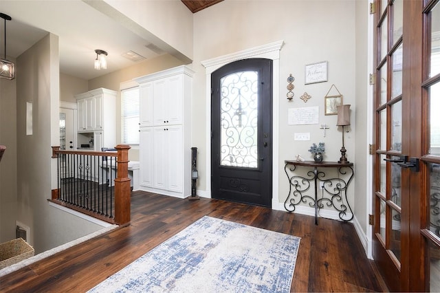 entryway with visible vents, baseboards, and dark wood finished floors