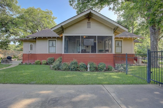 view of front of property featuring a sunroom, fence, and a front yard