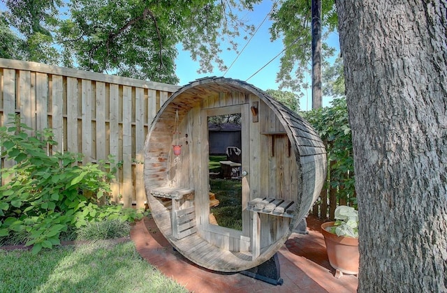 view of shed with fence