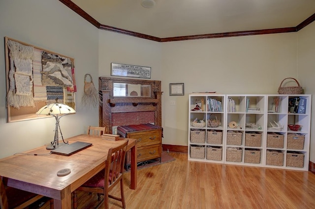 office with baseboards, ornamental molding, and wood finished floors