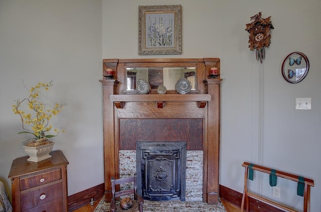 interior details with a fireplace and baseboards