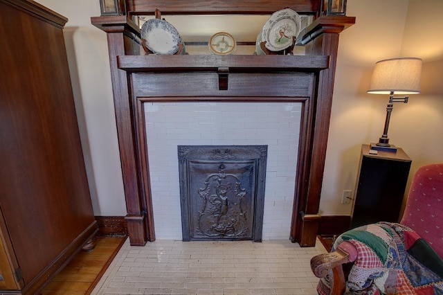 room details with a brick fireplace and baseboards