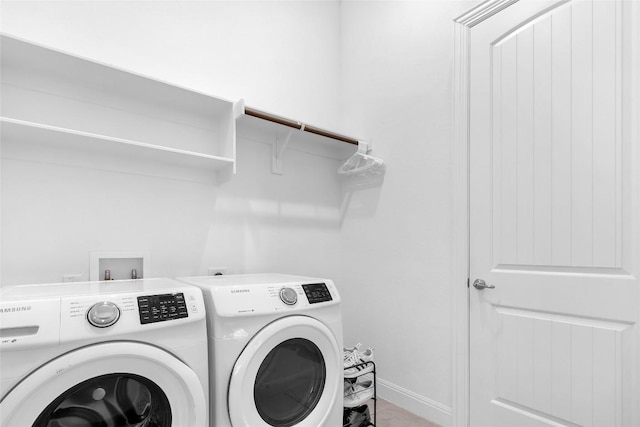 laundry room with laundry area, baseboards, and separate washer and dryer