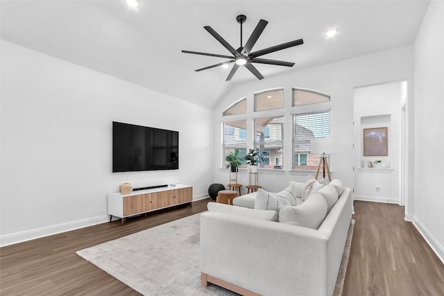 living room featuring lofted ceiling, baseboards, dark wood finished floors, and a ceiling fan