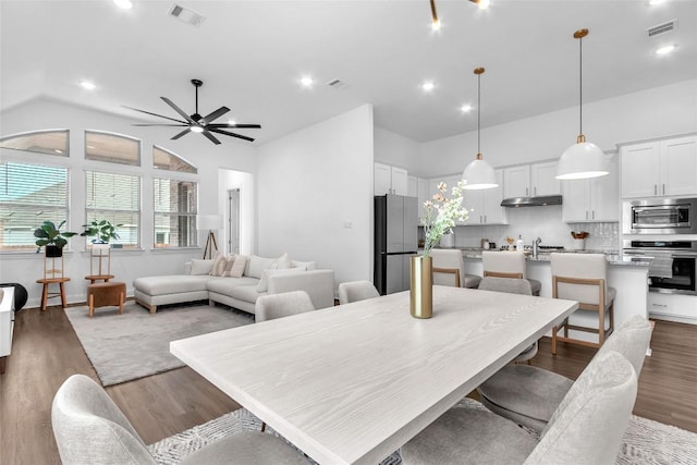 dining room with light wood-type flooring, visible vents, and ceiling fan