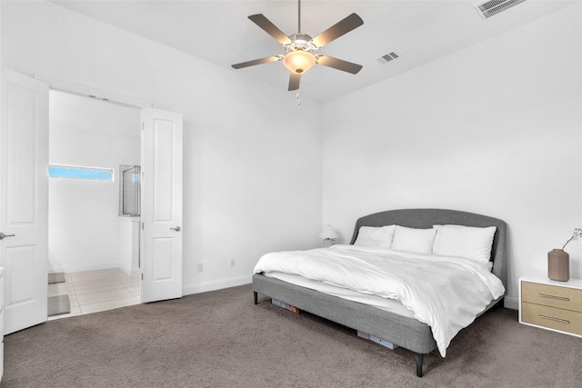 carpeted bedroom with ceiling fan, visible vents, and baseboards