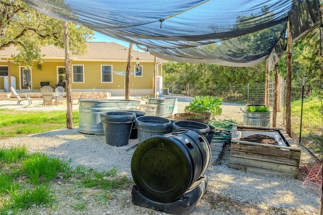 view of patio with a garden and fence