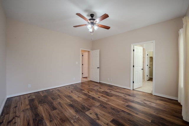 unfurnished bedroom featuring dark wood finished floors, a ceiling fan, and baseboards