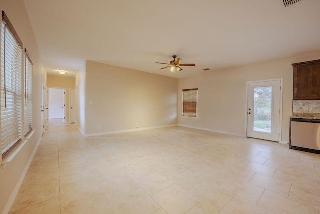 unfurnished living room with baseboards and ceiling fan