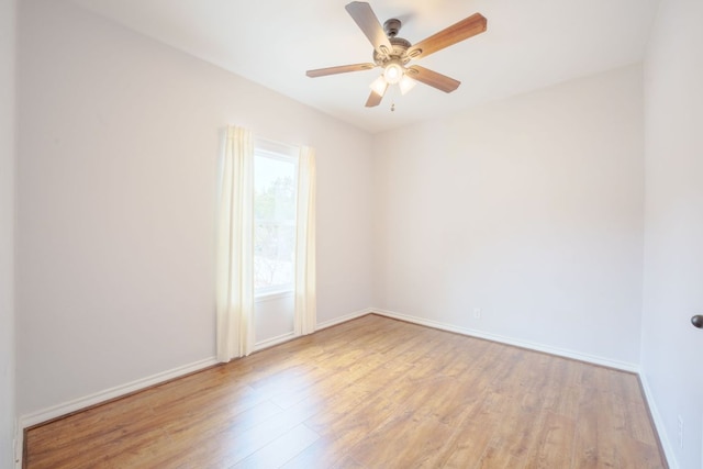 unfurnished room with wood finished floors, baseboards, and ceiling fan