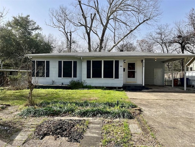 view of front facade featuring an attached carport, concrete driveway, a front yard, and entry steps