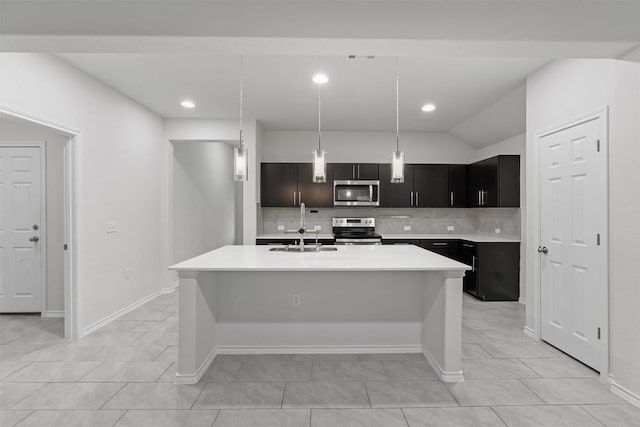 kitchen with appliances with stainless steel finishes, light countertops, a sink, and tasteful backsplash