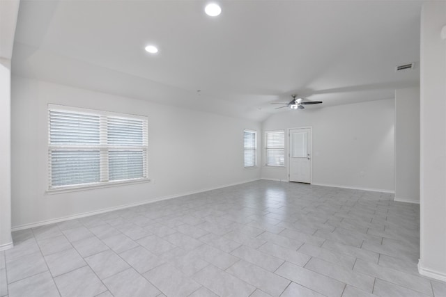 spare room featuring lofted ceiling, recessed lighting, visible vents, baseboards, and a ceiling fan