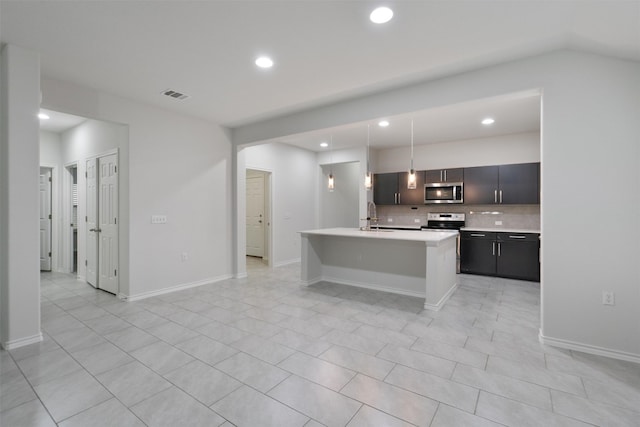 kitchen with light countertops, visible vents, backsplash, appliances with stainless steel finishes, and a sink