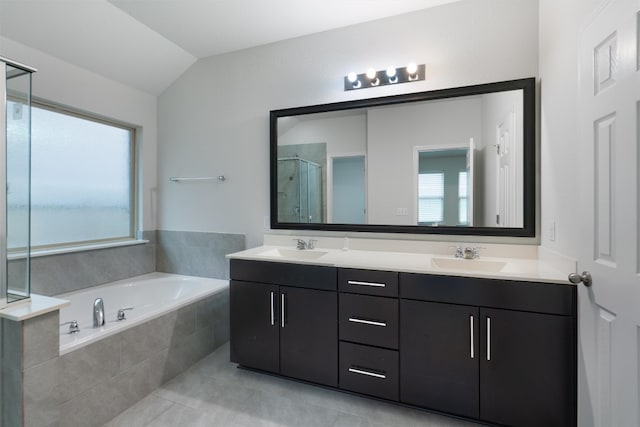 full bath with a stall shower, a sink, and a wealth of natural light