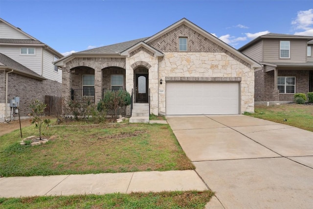 french provincial home with brick siding, a porch, concrete driveway, a front yard, and a garage