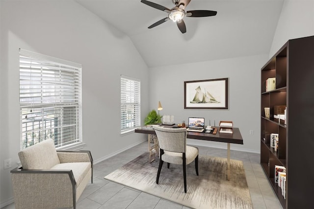 office space with ceiling fan, baseboards, vaulted ceiling, and light tile patterned flooring