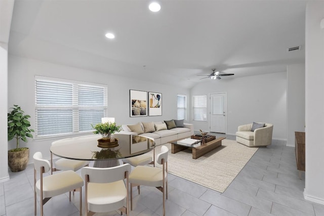 living area with lofted ceiling, light tile patterned floors, visible vents, and recessed lighting