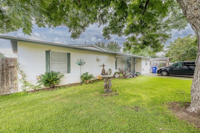 single story home featuring a front lawn and fence