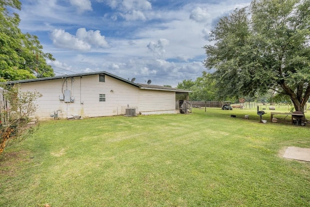 view of yard featuring cooling unit and fence